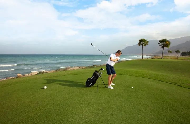 Jebel Sifah — golfer on the tee by the sea